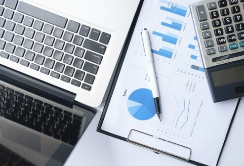 business-concept-with-copy-space-office-desk-table-with-pen-focus-analysis-chart-computer-notebook-cup-coffee-desk-vintage-tone-retro-filter-selective-focus_1418-555