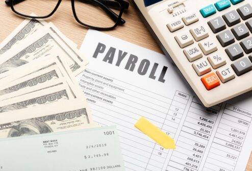 payroll-still-life-with-cash-high-angle_23-2149103937